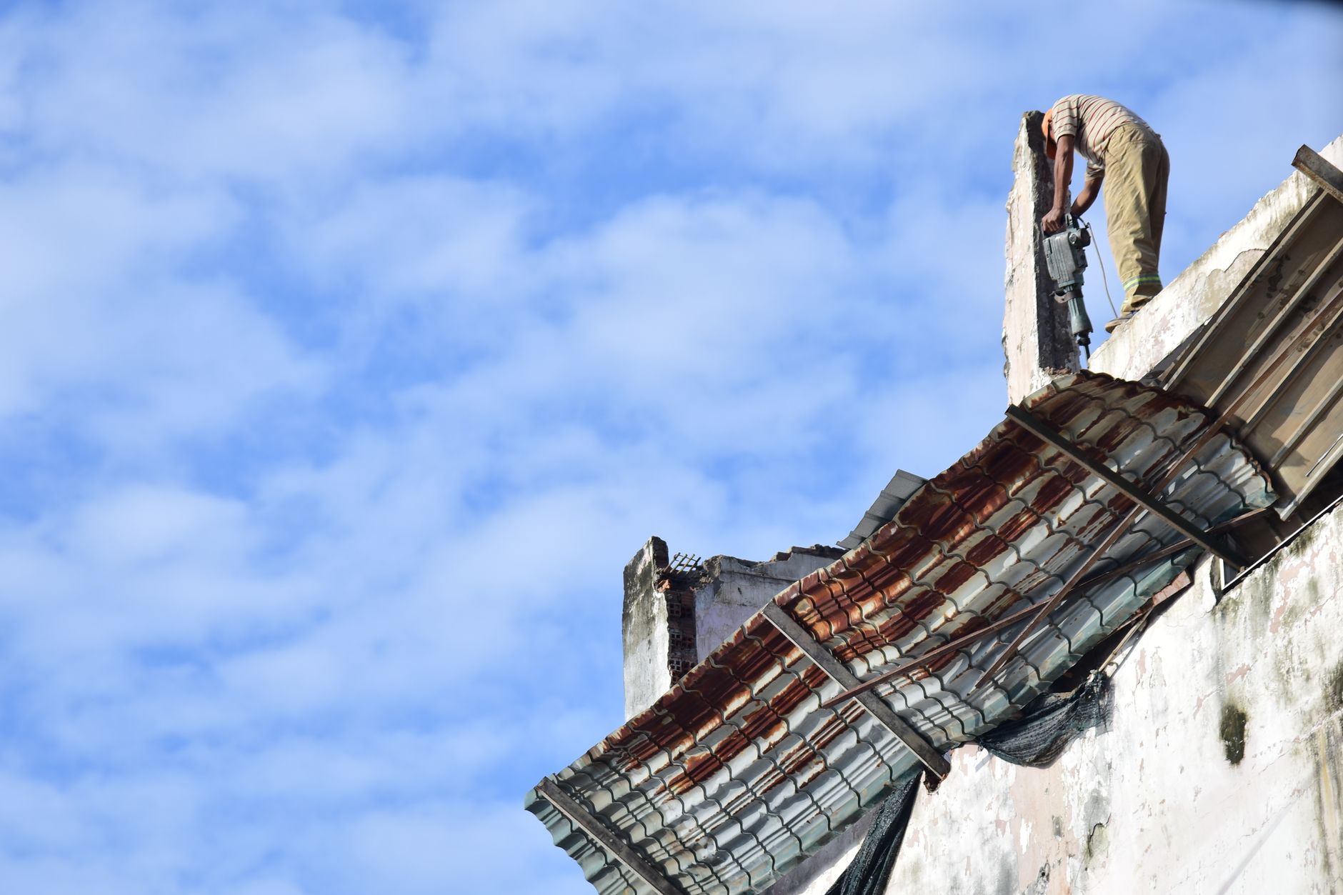 Construction worker at work against the sky.